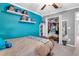 Bedroom featuring a ceiling fan, decor shelves, a full bed, and closet at 6653 Mineral Springs Rd, New Port Richey, FL 34653