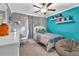 Bedroom featuring a ceiling fan, decor shelves, and a full bed at 6653 Mineral Springs Rd, New Port Richey, FL 34653