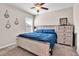 Cozy bedroom with a ceiling fan, a large bed, and a chest of drawers at 6653 Mineral Springs Rd, New Port Richey, FL 34653
