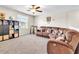 Spacious bonus room featuring plush carpeting and a comfortable, oversized sectional at 6653 Mineral Springs Rd, New Port Richey, FL 34653