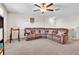 Bonus room showcasing a large sectional sofa, perfect for relaxation and entertaining at 6653 Mineral Springs Rd, New Port Richey, FL 34653