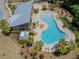 Overhead view of a stunning community pool, surrounded by lounge chairs and palm trees, perfect for relaxation at 6653 Mineral Springs Rd, New Port Richey, FL 34653