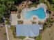 Aerial view of community pool area with lush landscaping, comfortable lounge chairs, and inviting blue water at 6653 Mineral Springs Rd, New Port Richey, FL 34653