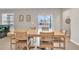 View of the dining room with a large table, view of sliding glass doors, and the pool beyond at 6653 Mineral Springs Rd, New Port Richey, FL 34653