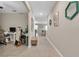 Spacious hallway leading to the dining area, complete with neutral walls and tile flooring at 6653 Mineral Springs Rd, New Port Richey, FL 34653