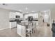 Modern kitchen with white cabinets, granite countertops, and stainless steel appliances at 6653 Mineral Springs Rd, New Port Richey, FL 34653