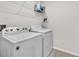 Laundry room showcasing a modern washer and dryer set with white finish at 6653 Mineral Springs Rd, New Port Richey, FL 34653