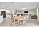 Open-concept living space with tile flooring and a large dining table connecting to the kitchen at 6653 Mineral Springs Rd, New Port Richey, FL 34653
