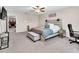 This carpeted bedroom includes a ceiling fan, desk, and storage bench at the foot of the bed at 6653 Mineral Springs Rd, New Port Richey, FL 34653