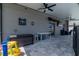 Covered outdoor entertainment area with ceiling fans and TV at 6653 Mineral Springs Rd, New Port Richey, FL 34653