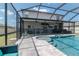 Backyard pool with full screen enclosure, small jacuzzi and entertainment area at 6653 Mineral Springs Rd, New Port Richey, FL 34653