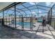 Screened pool with stone decking surrounded by a secure safety fence at 6653 Mineral Springs Rd, New Port Richey, FL 34653