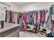 Walk-in closet with metal shelving containing clothes, shoes, and bags at 6653 Mineral Springs Rd, New Port Richey, FL 34653