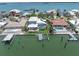 Aerial view of waterfront property highlighting a pool, private dock, and lush landscaping at 860 Harbor Is, Clearwater Beach, FL 33767