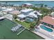 Beautiful waterfront home featuring a private dock, screened pool, lush landscaping, and breathtaking ocean views at 860 Harbor Is, Clearwater Beach, FL 33767