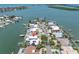 Stunning aerial view of waterfront home with lush landscaping, private pool, and solar panels at 860 Harbor Is, Clearwater Beach, FL 33767