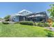 Backyard with a covered patio, lush landscaping, and a view of the well-maintained lawn at 860 Harbor Is, Clearwater Beach, FL 33767