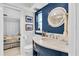 Nautical themed bathroom with vanity, round window and access into the bedroom at 860 Harbor Is, Clearwater Beach, FL 33767