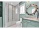 Modern bathroom featuring a decorative shower, sink with vanity, and a ship-themed mirror at 860 Harbor Is, Clearwater Beach, FL 33767