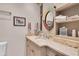 Elegant bathroom with marble countertop, stylish mirror, and storage at 860 Harbor Is, Clearwater Beach, FL 33767