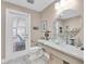 Beach themed bathroom with vessel sink, modern fixtures, and door to the outside patio at 860 Harbor Is, Clearwater Beach, FL 33767