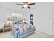 Bright bedroom with ceiling fan leads into the bathroom with coastal accents at 860 Harbor Is, Clearwater Beach, FL 33767