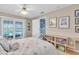 Light-filled bedroom with pool view, white metal frame bed, and decorative touches at 860 Harbor Is, Clearwater Beach, FL 33767