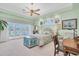 Waterfront bedroom with ceiling fan, sitting area and double doors that let in natural light at 860 Harbor Is, Clearwater Beach, FL 33767