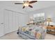 Bright bedroom with ceiling fan, closet with folding doors and side tables with bedside lamps at 860 Harbor Is, Clearwater Beach, FL 33767