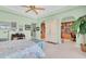Bedroom with ceiling fan leads into sitting room with built in bookcases and office space at 860 Harbor Is, Clearwater Beach, FL 33767