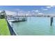 A modern boat dock on clear water with views of nearby waterfront homes and a sunny sky at 860 Harbor Is, Clearwater Beach, FL 33767