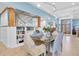 Elegant dining area with stylish chairs, a modern table, and built-in bookcase and staircase at 860 Harbor Is, Clearwater Beach, FL 33767