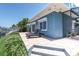 Brick patio next to blue house with outdoor seating overlooking the waterfront and private boat dock at 860 Harbor Is, Clearwater Beach, FL 33767