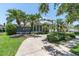 A beautiful two-story home featuring lush landscaping, a large driveway, and a white tiled roof at 860 Harbor Is, Clearwater Beach, FL 33767