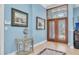 Inviting foyer with decorative front door, art, and a decorative foyer table with a vintage clock at 860 Harbor Is, Clearwater Beach, FL 33767