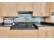 A view of the kitchen, featuring a cooktop with backsplash, cabinets and counter space at 860 Harbor Is, Clearwater Beach, FL 33767