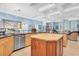 Modern kitchen with stainless steel appliances, a wood island, and open floor plan to living area at 860 Harbor Is, Clearwater Beach, FL 33767