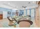 Bright living room with comfortable seating, nautical decor, and natural light from large windows at 860 Harbor Is, Clearwater Beach, FL 33767
