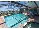 Relaxing screened-in pool with a jacuzzi, a patio, and views of the water at 860 Harbor Is, Clearwater Beach, FL 33767