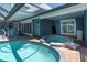 Backyard featuring a pool and a spa surrounded by a patio and a covered seating area at 860 Harbor Is, Clearwater Beach, FL 33767