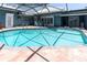 Large backyard pool featuring a covered patio, spa, and access to a waterfront view at 860 Harbor Is, Clearwater Beach, FL 33767