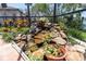 Backyard waterfall with rock landscaping, greenery, and waterfront views at 860 Harbor Is, Clearwater Beach, FL 33767