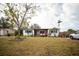 Charming single-story home with well-maintained lawn, brick accents, and cozy front porch sitting area at 8742 Narcissus Ave, Seminole, FL 33777