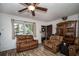 Cozy living room features wood-look floors, plush seating, and an abundance of natural light at 8742 Narcissus Ave, Seminole, FL 33777