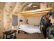 Attic room featuring exposed insulation, bed, and storage at 8742 Narcissus Ave, Seminole, FL 33777