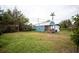 Exterior shot of blue backyard shed with small porch at 8742 Narcissus Ave, Seminole, FL 33777
