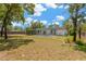 This sprawling backyard features mature trees, and a screened patio and pool, offering a private outdoor retreat at 9013 Nakoma Way, Weeki Wachee, FL 34613