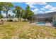The property features a large backyard with a screened patio and pool, offering a private outdoor oasis at 9013 Nakoma Way, Weeki Wachee, FL 34613