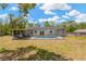 A view of the backyard featuring a screened in pool and patio area, perfect for enjoying the outdoors at 9013 Nakoma Way, Weeki Wachee, FL 34613