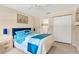 Well-lit bedroom with a large bed, carpeted floors, and an ensuite bathroom at 9013 Nakoma Way, Weeki Wachee, FL 34613